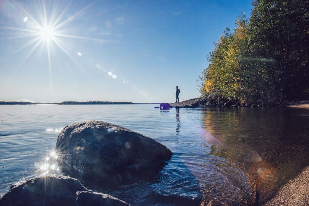 The sun shining over the water on a beautiful autumn day